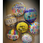 Assorted birthday and congratulatory foil balloons in a box