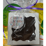 Wrapped birthday gift box with a clear window and purple ribbon