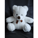 White teddy bear with a brown ribbon bow on a dark background
