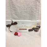 Box of assorted chocolates with two glitter heart decorations