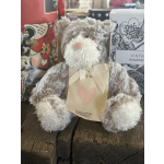 Plush teddy bear with a heart tag and ribbon