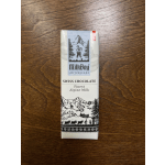 MilkBoy Swiss chocolate bar in white wrapper on a wooden surface