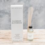 Reed diffuser bottle with boxed packaging on a wooden surface