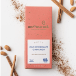 Coral chocolate bar with cinnamon sticks, almonds, and cinnamon powder on white background