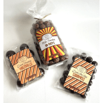 Three bags of assorted chocolate candies on a white surface