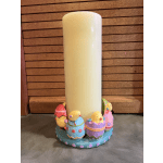 White pillar candle on a pastel Easter chick candle holder