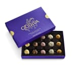 Open purple Godiva chocolate box with assorted truffles in a tray