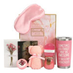 Pink gift set with a sleep mask, teddy bear, soap, candle, and dried flowers