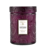 Purple patterned candle jar with a lid and label