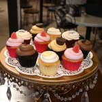 Assorted cupcakes on a decorative gold stand