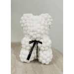 White teddy bear made of fluffy pom-poms with a black ribbon bow