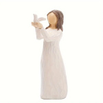 White figurine of a girl holding a dove