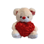 White teddy bear holding a red heart