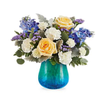 Bouquet of yellow roses, blue hydrangeas, and white flowers in a blue vase