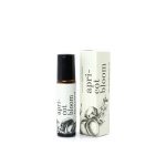 A small perfume roller bottle beside its matching box