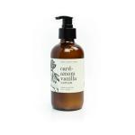 Amber pump bottle of cardamom vanilla lotion on a white background