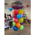 A large birthday balloon bouquet with a "Happy Birthday" foil balloon