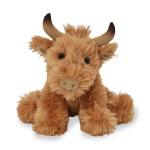 Plush brown cow toy with horns on a white background