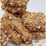 Nut-covered candy pieces on a white surface