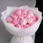 Bouquet of pink peonies wrapped in white paper