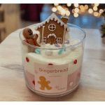 Gingerbread-themed candle in a clear glass container