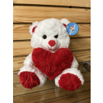 White teddy bear holding a red heart