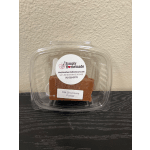 Plastic clamshell container holding a block of milk chocolate fudge
