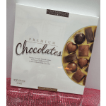 Box of assorted premium chocolates with a white package and gold tray graphic