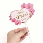 Hand holding a pink Mother's Day orchid pick with a heart-shaped sign
