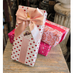 Three heart-patterned gift boxes tied with ribbons