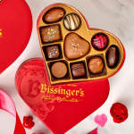 Heart-shaped box of assorted chocolates on a red heart box