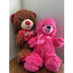 Two plush teddy bears, one brown holding a red heart and one pink with a ribbon