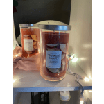 Two Yankee Candle jars with orange-red wax and silver lids