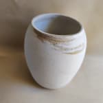 White ceramic vase with brown speckled glaze near the rim