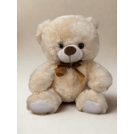 Cream-colored teddy bear with a brown ribbon bow