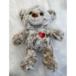 Plush teddy bear with a red heart on its chest
