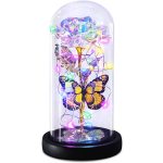 Iridescent artificial rose with butterflies and multicolor lights in a glass dome on a black base