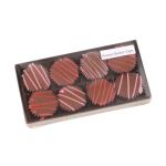Box of peanut butter cups with pink and red drizzle