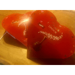 Two heart-shaped Lindor chocolate boxes on a wooden surface