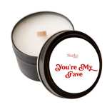 Black candle tin with white wax and a lid reading "You're My Fave"