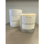 Two scented candles in white and clear glass containers