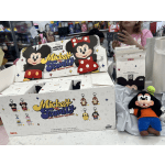 Mickey Mouse Family keychain boxes and a plush toy on a counter