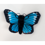 Blue and black butterfly plush toy on a white background