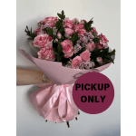 Pink rose bouquet wrapped in pink paper with a satin ribbon