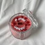 Pink candle in a clear glass jar with a lid and "I LOVE YOU" beads