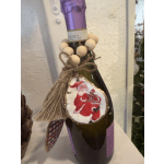 Decorated wine bottle with rustic holiday ornament and twine tag