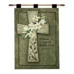 Decorative wall hanging with a cross, white lilies, and the words Peace I Leave With You