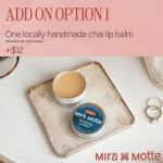Lip balm tin on a tray with rings nearby