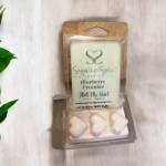Packaged blueberry crumble wax melts in a clear plastic clamshell