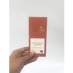 Hand holding a box of milk chocolate cinnamon artisan chocolate